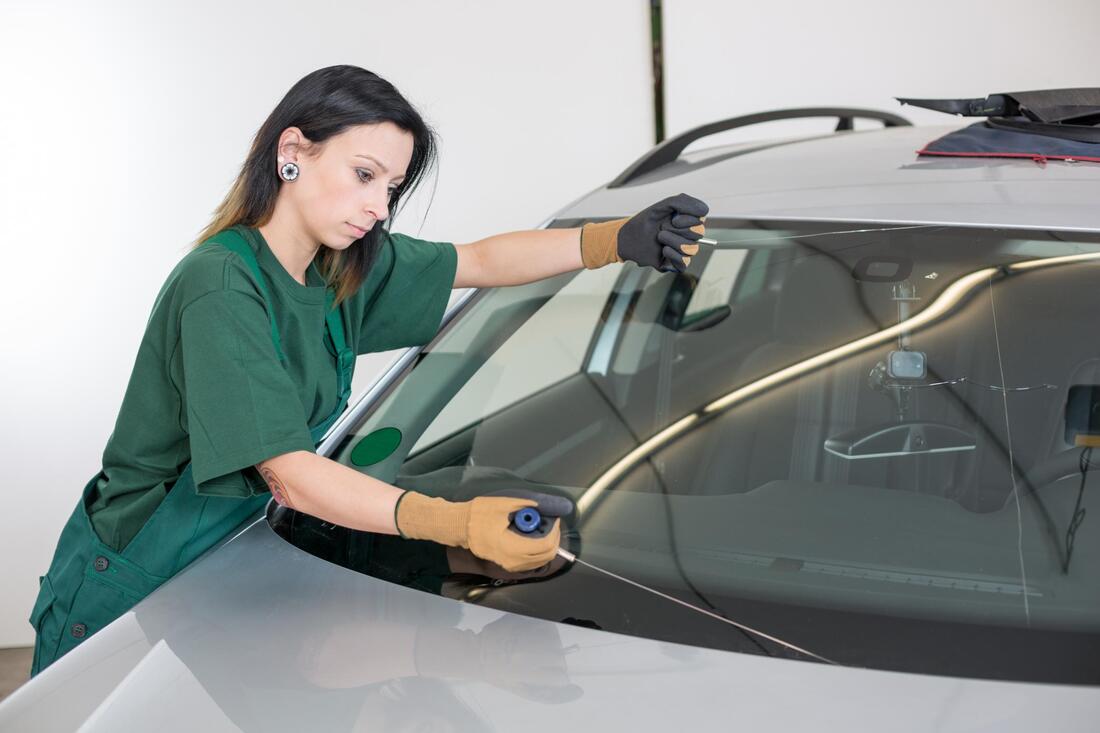 woman checks on windshield